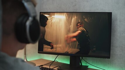 Poster - young boy wearing headphones watches online thriller movie with fight on personal computer sitting a