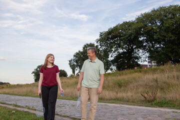 Wall Mural - father and daughter playing badminton outdoor