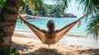 © Thanos - A Woman Relaxing in Hammock on Beach