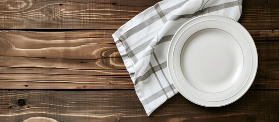 Poster - Wooden table background with an empty white plate and napkin providing a clean and classic copy space image