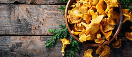 Aufkleber - Fresh chanterelle mushrooms make a delicious snack on the rustic table with a copy space image background in a top view