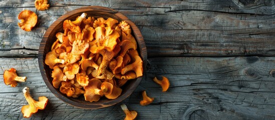 Aufkleber - Fresh chanterelle mushrooms make a delicious snack on the rustic table with a copy space image background in a top view
