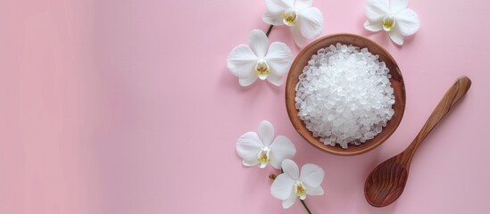 Wall Mural - Flat lay setup featuring white spa sea salt a white orchid and room for text on a pink backdrop embodying a spa beauty concept with a serene top down view Embracing meditation and minimalism with a c