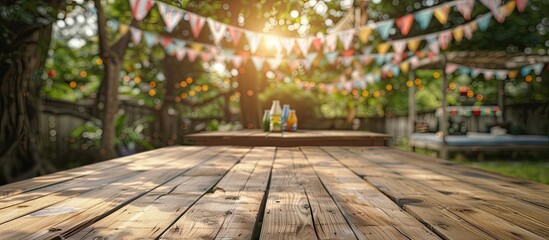Poster - An empty wooden table set up in a backyard party scenario with festive bunting decorations in the background ideal as a copy space image