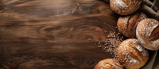 Poster - Overhead shot of diverse homemade multigrain bread loaves on a wooden surface with a blank space for an image. Creative banner. Copyspace image