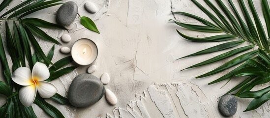 Aufkleber - Zen like grey stones a candle flower and palm leaves arranged on white stone background for a relaxing spa concept viewed from above with empty space for text or image. Creative banner