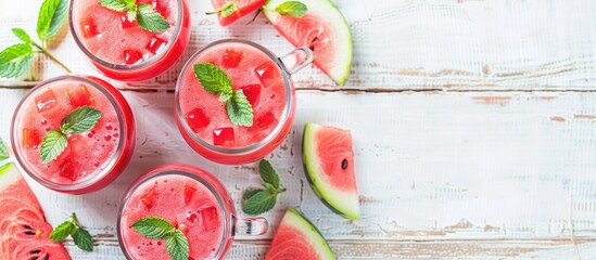 Poster - Refreshingly colorful summer drinks like cold watermelon juice smoothies in glasses on a light white wood background with copy space for images embody the essence of a healthy food and drink choice in