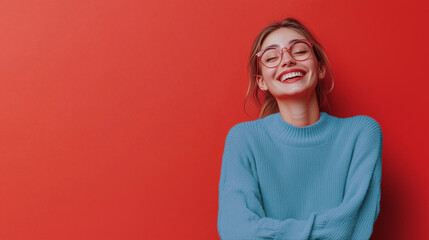 Portrait of a beautiful young woman with glasses, isolated on a red background. smiling confidently with room on the side for a news title or sales post.