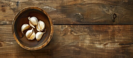 Aufkleber - Wooden bowl with three garlic cloves with open area for copy space image