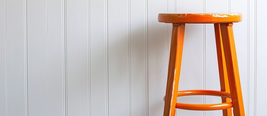 Poster - Orange stool set against a white backdrop with copy space image