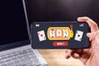© fadfebrian - Man playing online casino gambling on a mobile phone and winning jackpot