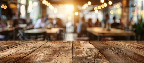 Fototapete - Copy space image of a wooden table top in a bustling cafe with a blurred background of people ideal for display montage