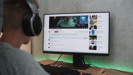 Poster - caucasian teenager in headphones watches educational video about color grading on personal computer 