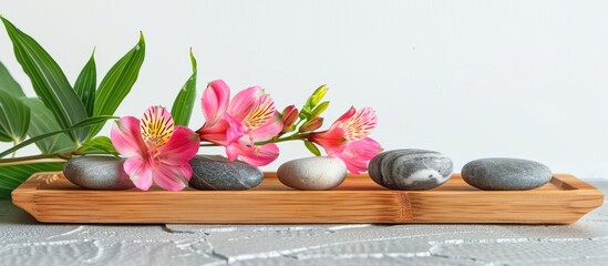 Aufkleber - Spa stones alongside alstroemeria and bamboo in a wooden tray with water isolated on white. with copy space image. Place for adding text or design