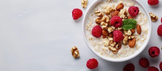 Poster - oatmeal topped with nuts and raspberries. with copy space image. Place for adding text or design