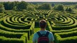 © StasySin - A person stands before an intricate garden maze