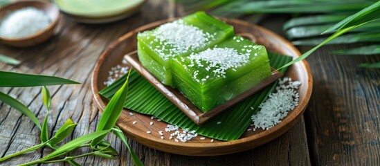 Leinwandbilder - Top view of three green pandan sticky rice cakes on a wooden floor background copy space