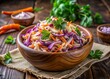 © Sirinporn - Vibrant coleslaw salad featuring shredded purple cabbage and carrot, mixed with creamy dressing, garnished with fresh parsley, and served in a rustic wooden bowl.