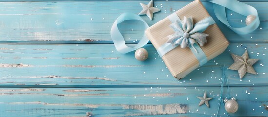 Wall Mural - Flat lay of a gift box adorned with a striped red ribbon and a wooden star on a pastel blue background Concept of Christmas New Year and winter holidays Top view with copyspace