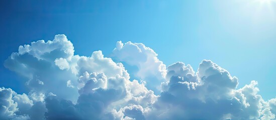 Sticker - Clear blue sky with fluffy white clouds on a sunny summer day providing an empty background for a potential copy space image