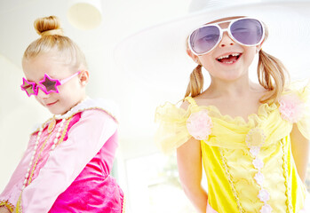 Princess, friends and children dress up in home with fun, glamour and confidence with sunglasses for character play. Fancy, costume and happy girl kids with smile, fantasy and creative development.