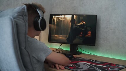 Poster - caucasian teenager in headphones watches action movie with fight online on personal computer while s