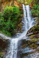 Wall Mural - Waterfall in the rainforest with water crashing against rocks in Minas Gerais, Brazil