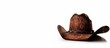 © StockKing - Isolated brown cowboy hat on a white background with copy space image.