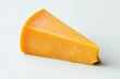 © anzodesign - Elegant close-up of a wedge of aged cheddar cheese on a white background