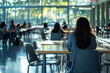 © Alexandra - Teenage girl sitting alone in a crowded high school cafeteria feeling sad and excluded