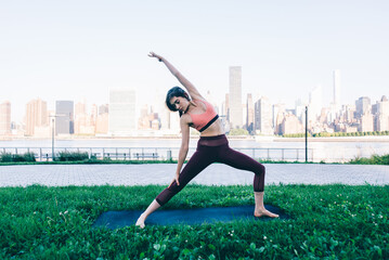 Beautiful girl making morning yoga training in New york