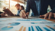 © imran - business leader reviewing financial forecasts with team