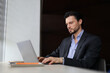 © Andrii Zastrozhnov - A man in a suit is typing on a laptop computer. He is focused on his work, possibly a business meeting or a project. Concept of professionalism and productivity, as the man is dressed in a suit