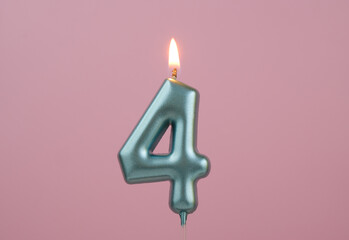 Burning blue birthday candle on pink background, number 4