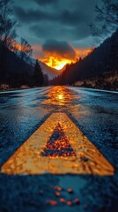 Poster - A stunning display of colors as the sun sets behind the mountains, illuminating a wet road with a vibrant golden hue