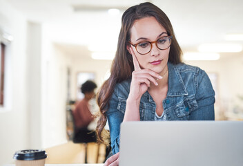 Canvas Print - Business, laptop and thinking with designer woman in office for administration or problem solving. Computer, glasses and idea with employee in creative workplace for digital agency for research