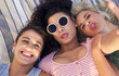 © Frank Coop/peopleimages.com - Above, portrait and women with selfie outdoor for summer vacation, goofy memory or social media update of bonding. Friends, silly and photography for profile picture post, sunglasses and fun together