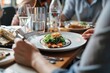 © Iftikhar alam - A group of people sitting at a table, engaging in a meal with plates of food, while a nutritionist discusses meal plans with a client, Nutritionist discussing meal plans with a client