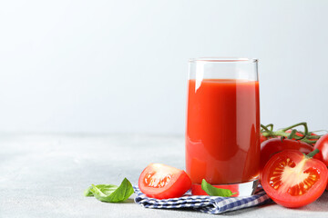 Sticker - Tasty tomato juice in glass with fresh vegetables and basil leaves on light grey table, space for text