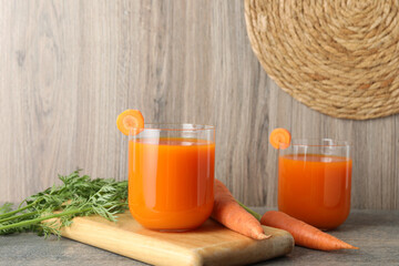 Sticker - Healthy carrot juice in glasses and fresh vegetables on wooden table