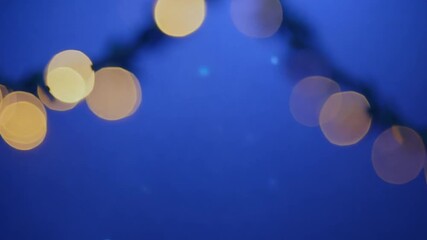 Poster - Christmas Garland Bokeh Lights on Blue Background for Holiday Decor Generative AI