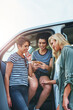 © Frank Coop/peopleimages.com - Girls, road trip and mobile phone by vehicle as friends on vacation, holiday or weekend for activity or directions. Female people, technology and talking for fun, outdoor or ideas for plan in Greece