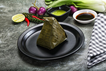 Wall Mural - Asian cuisine - rice with filling in banana leaf