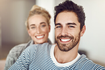 Couch, portrait and couple together in living room for bonding, care and affection for romance in home. Woman, man and happy in lounge, apartment or house for weekend relaxing rest on sofa with smile