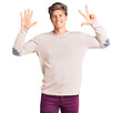 © Krakenimages.com - Young handsome man wearing casual clothes showing and pointing up with fingers number eight while smiling confident and happy.