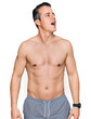 © Krakenimages.com - Handsome young man wearing swimwear shirtless angry and mad screaming frustrated and furious, shouting with anger. rage and aggressive concept.