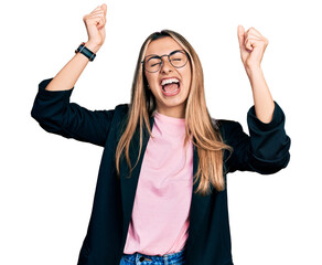 Wall Mural - Hispanic young woman wearing business jacket and glasses dancing happy and cheerful, smiling moving casual and confident listening to music