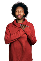 Poster - African american woman with afro hair wearing turtleneck sweater smiling with hands on chest with closed eyes and grateful gesture on face. health concept.