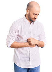 Sticker - Young handsome man wearing elegant shirt with hand on stomach because indigestion, painful illness feeling unwell. ache concept.