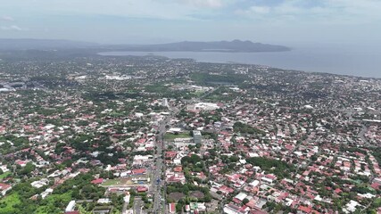 Sticker - Managua, Nicaragua - August 16, 2024: Managua town landscape on lake background aerial drone view